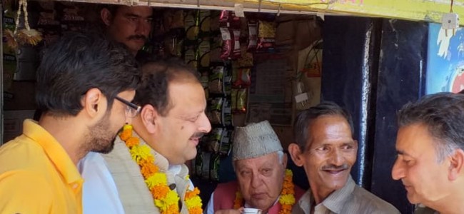 Farooq sips tea at a stall in  congested old Jammu city market; interacts with people, tourists